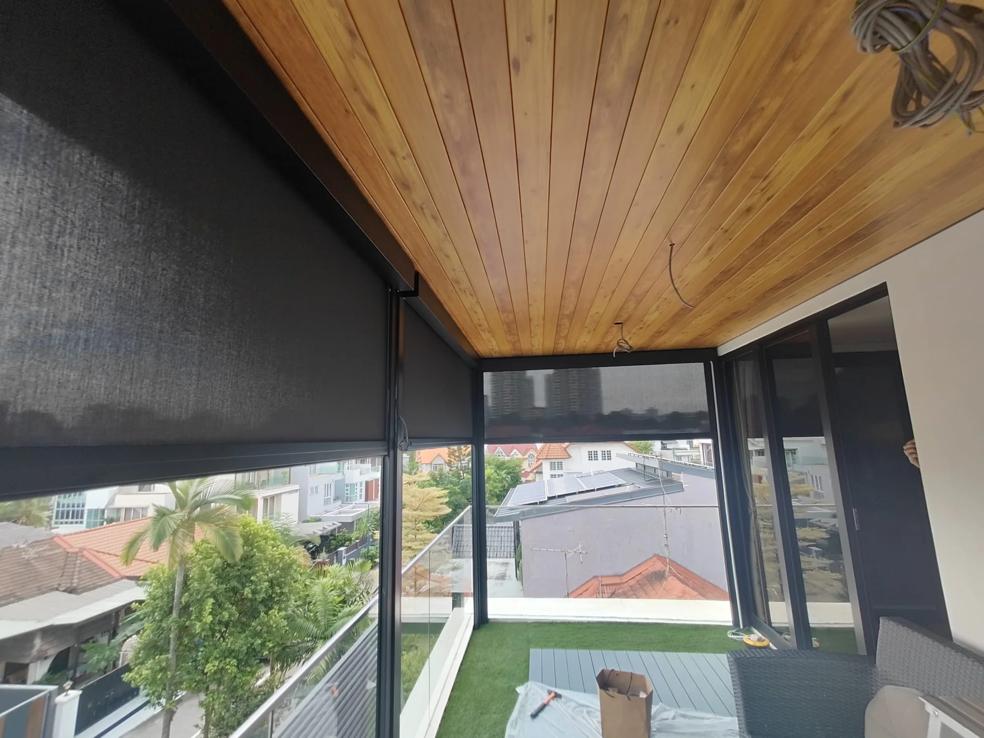 Finished ceiling above an outdoor space with lowered side blinds