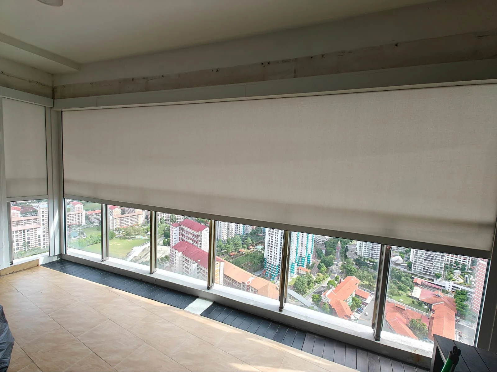 Outdoor zip blind fabric lowered across balcony openings